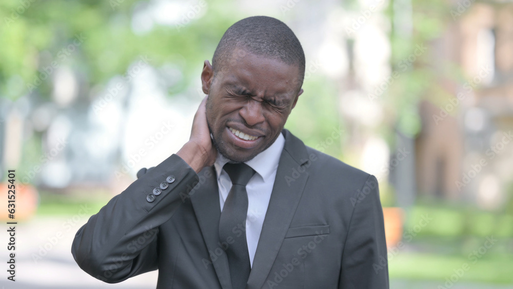 Outdoor Portrait of Tired African Businessman with Neck Pain Outdoor Portrait of Tired African Businessman with Neck Pain