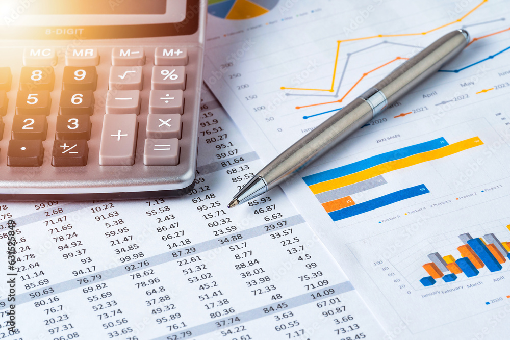 Pen and Calculator on business data report, sales statistics chart or graph. Business or financial concept. Pen and Calculator on business data report, sales statistics chart or graph. Business or financial concept.