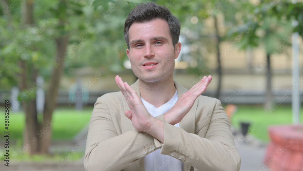 Outdoor Portrait of Casual Young Man in Denial, Stop Gesture Outdoor Portrait of Casual Young Man in Denial, Stop Gesture