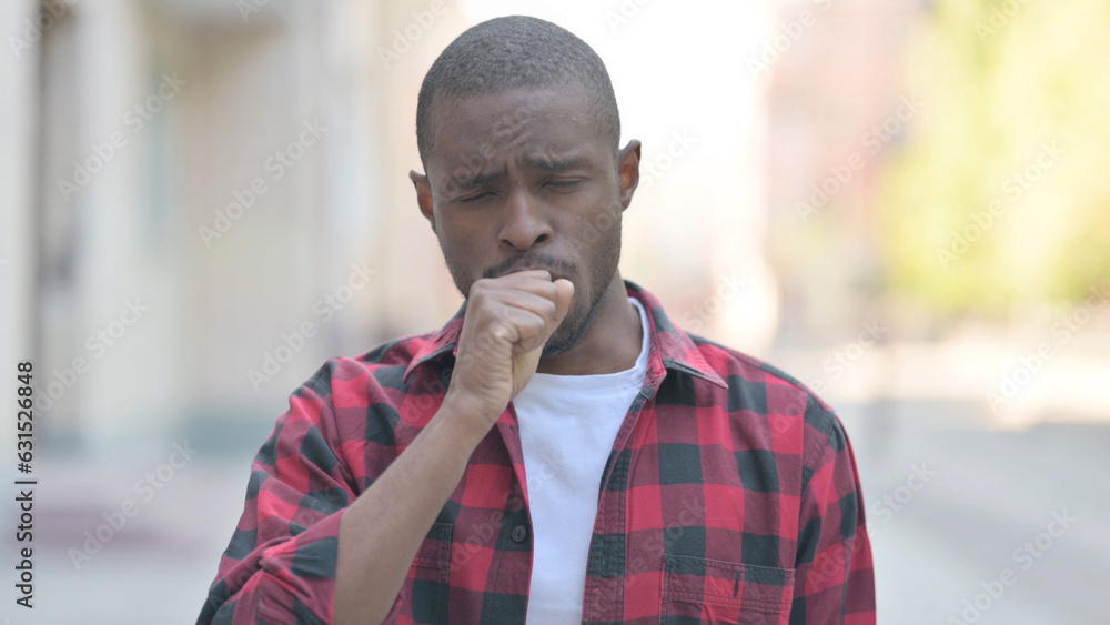 Fototapeta premium Outdoor Portrait of Young African Man Coughing