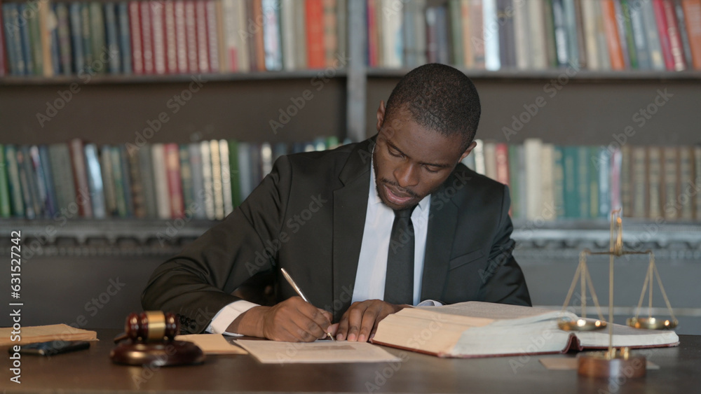 Fototapeta premium Pensive African Male Lawyer Reading Law Book, Preparing for Court