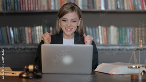 Excited Young Female Lawyer Celebrating Success on Laptop
