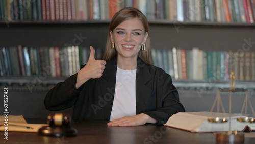Thumbs Up by Young Female Lawyer in Office © stockbakers