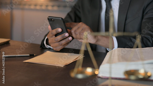 African Judge using Smartphone in Cour, Close Up