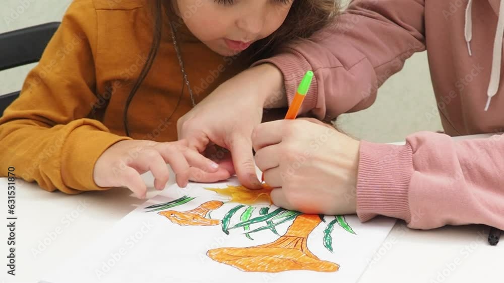 Small preschooler girl sit at desk study online on phone, smart little kid wear learning using internet lessons on quarantine, homeschooling. Draws with felt-tip pens and colored pencils, imagination Small preschooler girl sit at desk study online on phone, smart little kid wear learning using internet lessons on quarantine, homeschooling. Draws with felt-tip pens and colored pencils, imagination