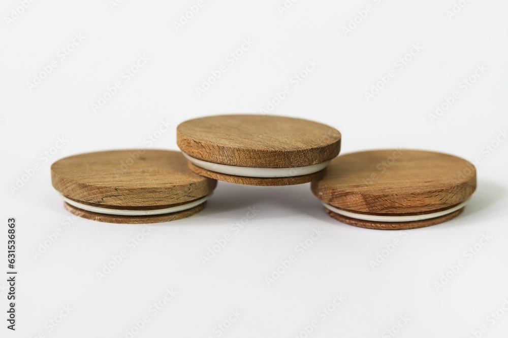 Round bamboo lids of jar arranged on top of a white background with copy space Round bamboo lids of jar arranged on top of a white background with copy space