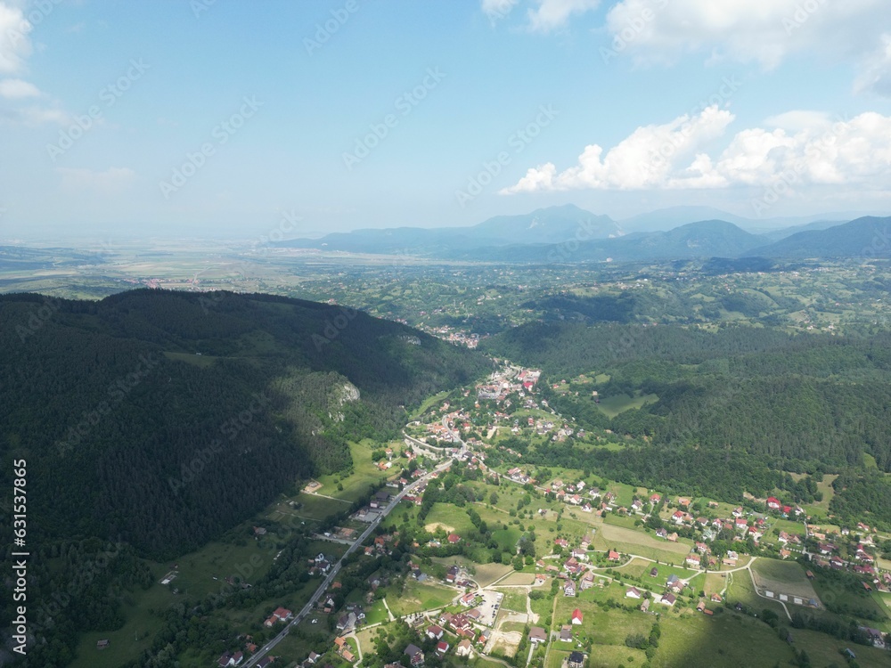 Idyllic rural landscape with the village of Moieciu de Jos, Romania, summertime