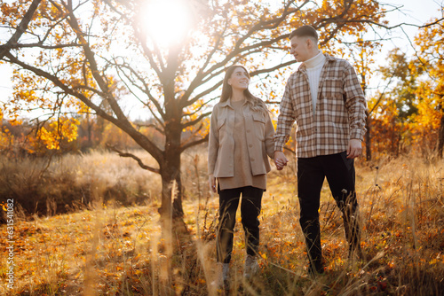 Happy couple walk and enjoy each other in sunny autumn park. Enjoying time together. Lifestyle. Style concept  autumn fashion.