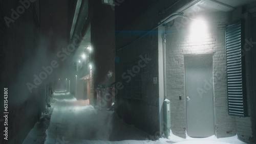 Empty alleyway on a snowy freezing-cold winter night. photo