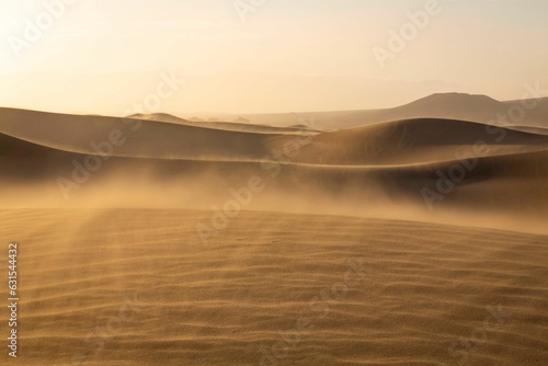 Obraz na plátne Vast expanse of golden sand with a deep blue sky in the background