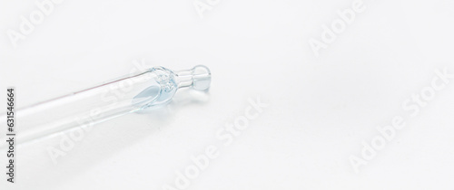 Cosmetic pipette with blue and blue gel, serum, serum on a light background.