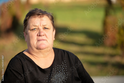 Belarus, a village near the city. October 22, 2021. Photographing ordinary elderly people. Close-up portrait of an elderly very plump woman with a short haircut.