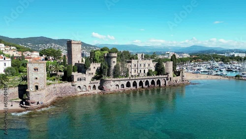 Drone footage over the sea and stone Chateau de la 
Castle in Mandelieu-La Napoule, France photo