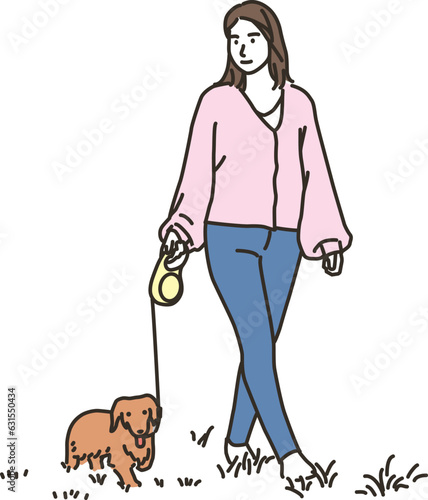 屋外で犬と散歩する若い女性
