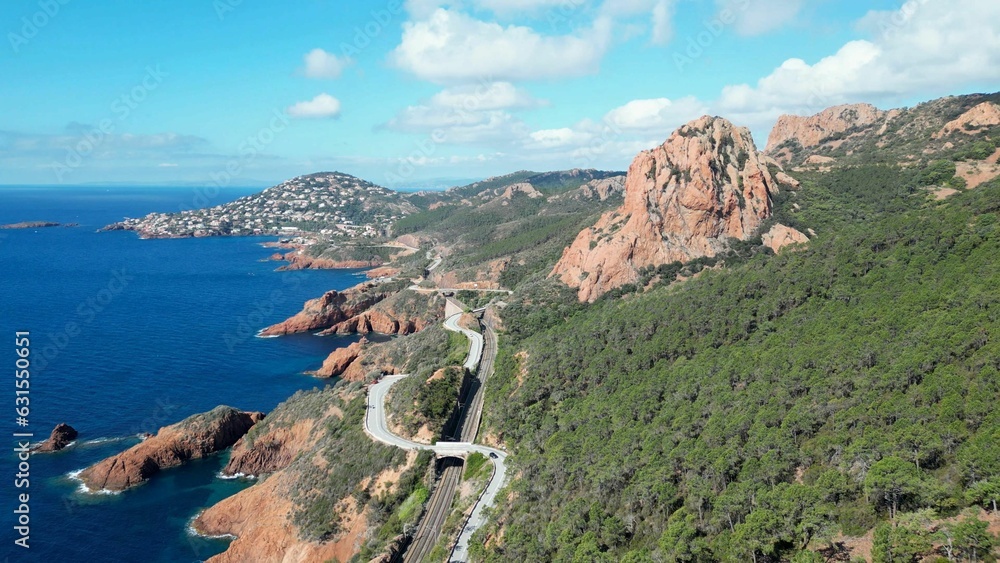 Aerial view of a blue sea and green mountains on the shore. Antheor, Massif de l'Esterel.