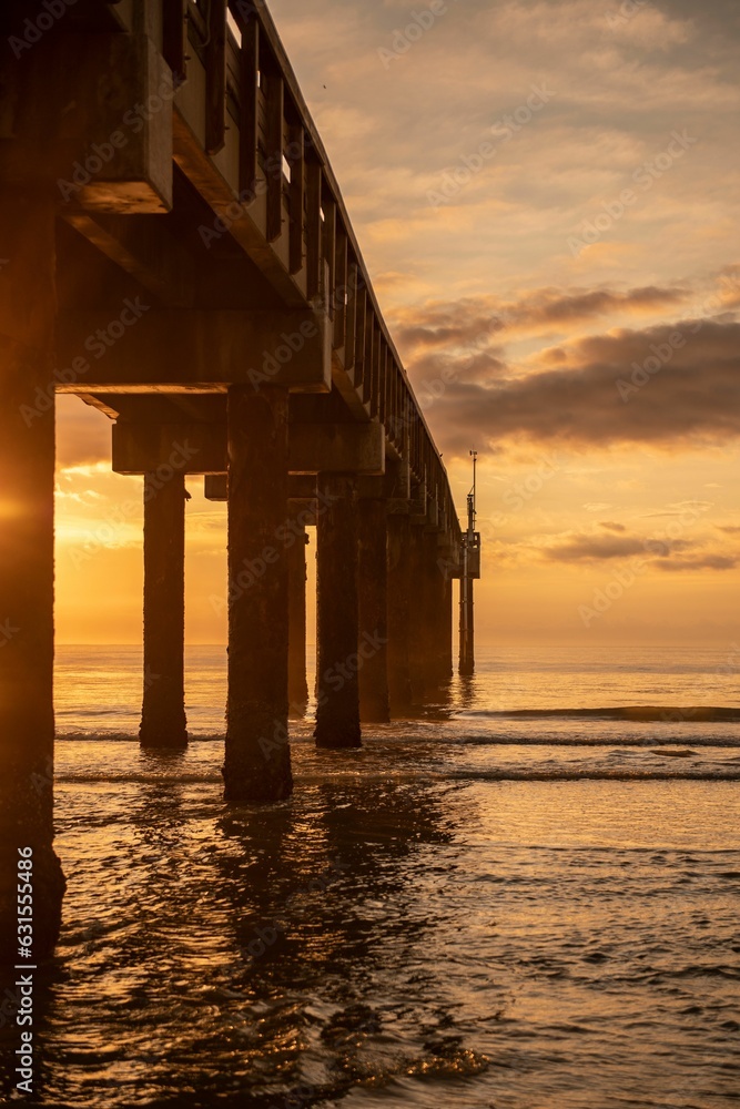 Mesmerizing sunset over the pier on beach in St. Augustine, Florida