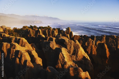 Big rocks by the wavy beach