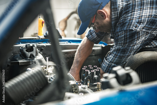Car Mechanic Repairs a Classic Car Inside His Workshop