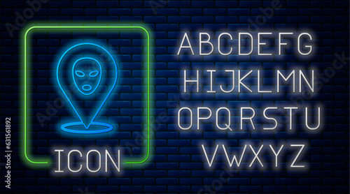 Glowing neon Alien icon isolated on brick wall background. Extraterrestrial alien face or head symbol. Neon light alphabet. Vector