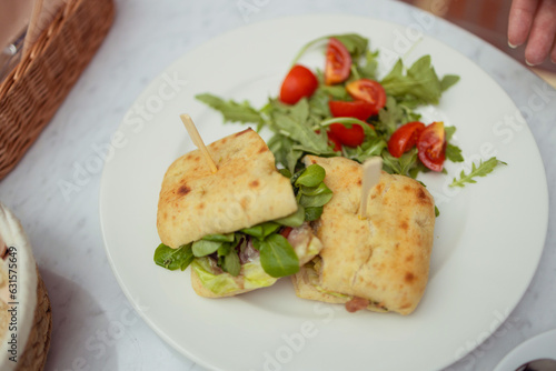 Healthy chicken and spinach sandwiches and fresh vegetable salad on the table at city cafe. Healthy diet food concept. for breakfast or lunch. Vegetarian food. Vegan menu. Long banner format. High