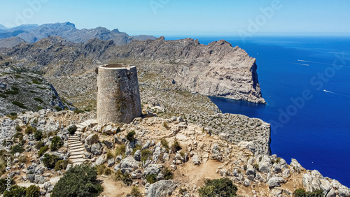 Aerial view of the Albercutx watchtower, an ancient fortified building sitting at the top of a mountain of Cape Formentor on the northeastern coast of Mallorca in the Balearic Islands, Spain photo
