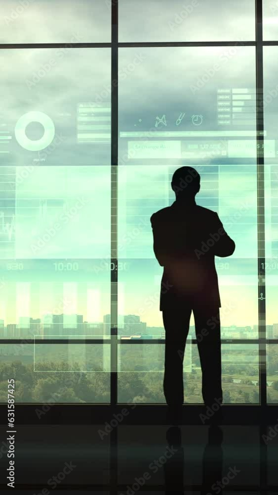 Silhouette of a trader in the office before infographics Silhouette of a trader in the office before infographics
