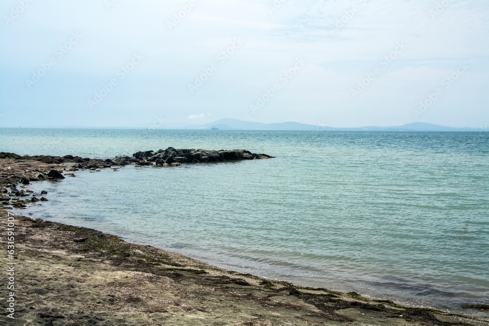 The calm sea near Sarafovo and the famous black sand common in the region of Burgas
