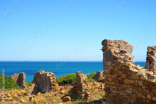 old stone ruins walls in front of the blue Mediterranean Sea near La Alcaidesa in Andalusia, Spain