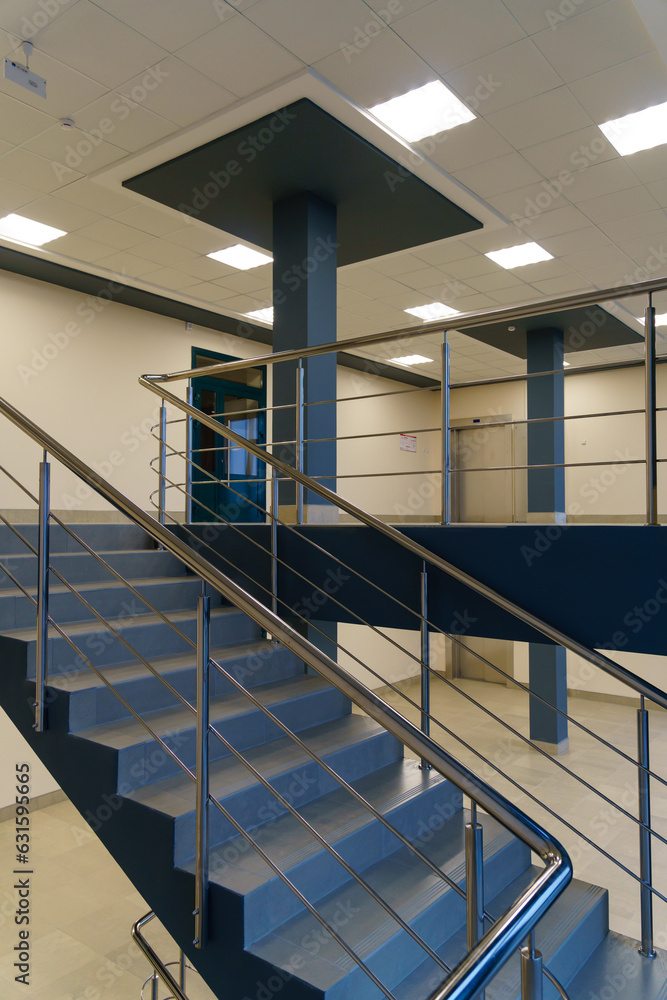 Fototapeta premium Stairwell in a modern building. Staircases as an emergency evacuation exit from the building in case of fire or emergency. Clean stairs and railings in the business center.