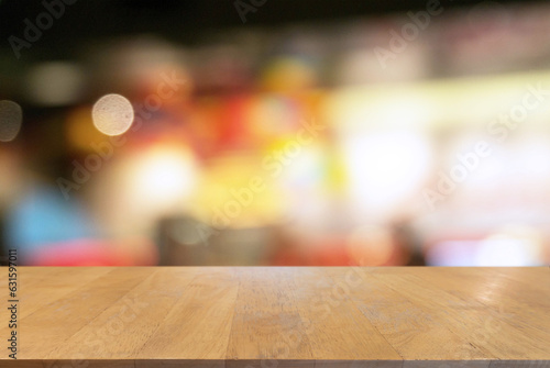 Empty wooden table in front of abstract blurred background of coffee shop . can be used for display Mock up of product