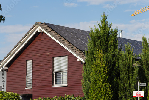 prefabricated building front of wood construction with solar panels on rooftop photo