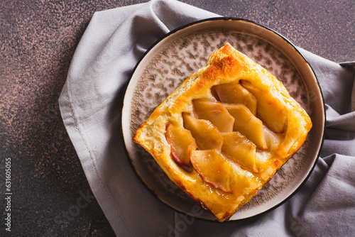 Close up of upside down puff pastry apple tart on a breakfast plate top view