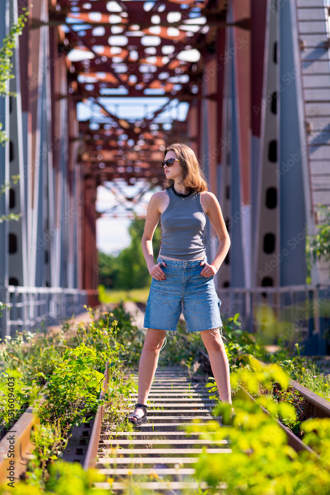 Young woman standing in the middle of the rail