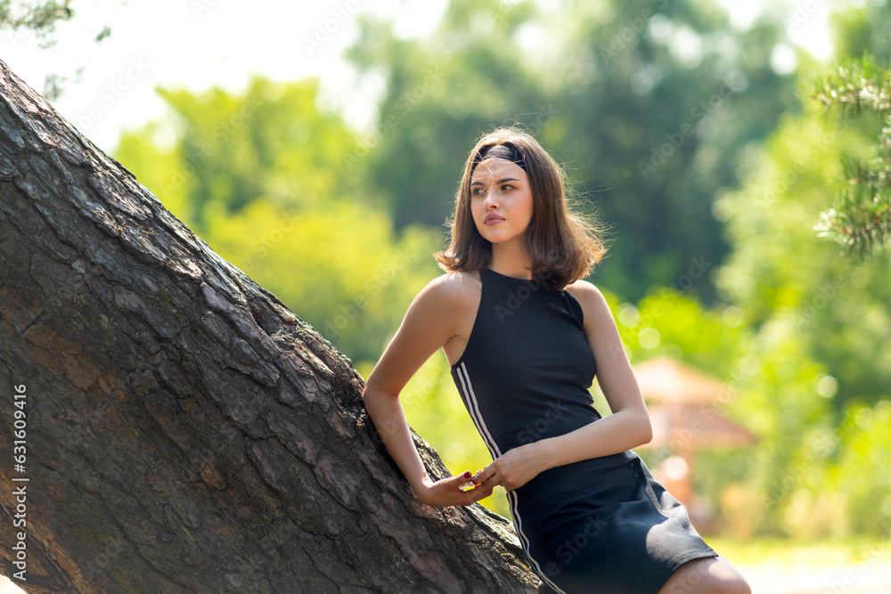 A sporty girl is resting in nature
