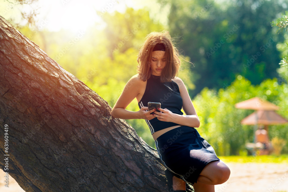 Girl looking at the phone in nature
