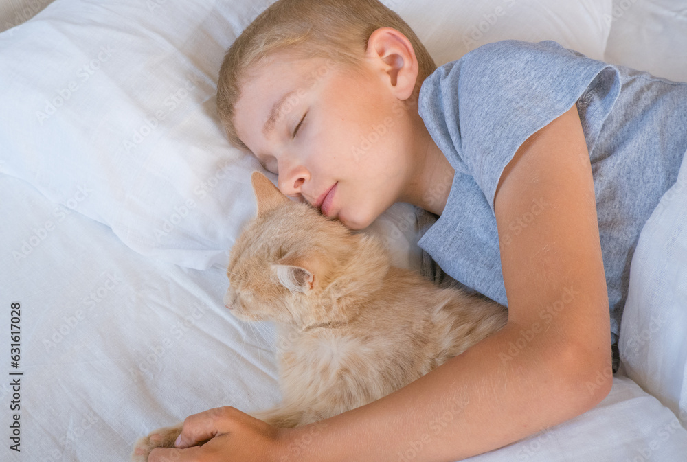 A child in bed cannot fall asleep, yawns, grimaces and plays with a ginger cat. A child in bed cannot fall asleep, yawns, grimaces and plays with a ginger cat.