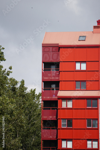 Red colored residential flat in Almere Buiten, 'red thunders' building cropped image, Flevoland polder area, Netherlands, zoomed houses from front perspective, portrait size, 'red devils' residential photo