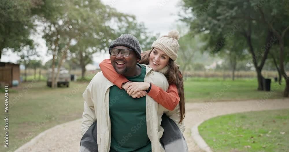 Interracial couple, piggyback and walking in park for bonding, love or care together in the outdoors. Happy man and woman enjoying back ride, scenery or natural environment on weekend holiday outside Interracial couple, piggyback and walking in park for bonding, love or care together in the outdoors. Happy man and woman enjoying back ride, scenery or natural environment on weekend holiday outside