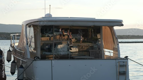 Mirror reflection on boat of people on the pier