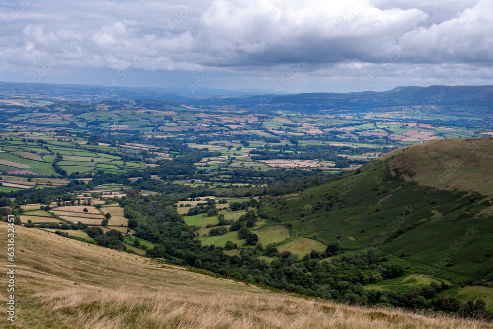 View from Bryn Teg ridge on a cloudy summer afternoon in the Brecon Beacon or Bannau Brycheiniog national park, Powys, Wales