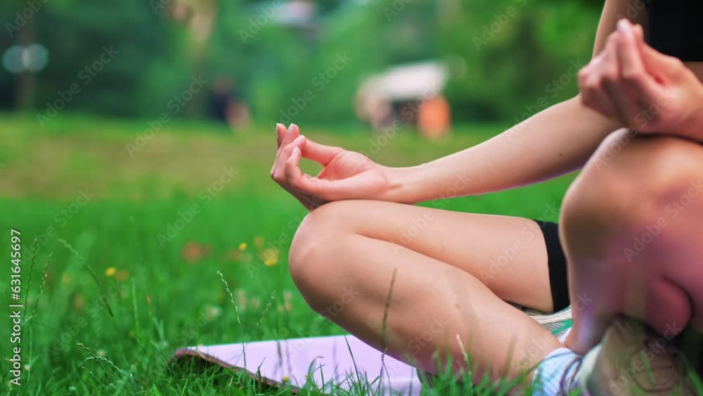 Young healthy girl practicing yoga at summer evening, shallow dof, close up on girls hand, fitness health nature energy concept, shot in 4K UHD Young healthy girl practicing yoga at summer evening, shallow dof, close up on girls hand, fitness health nature energy concept, shot in 4K UHD