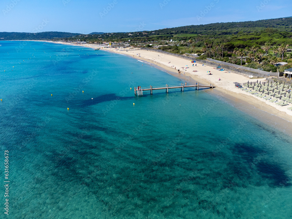 Crystal clear blue water of legendary Pampelonne beach near Saint-Tropez, summer vacation on white sandy beach of French Riviera, France