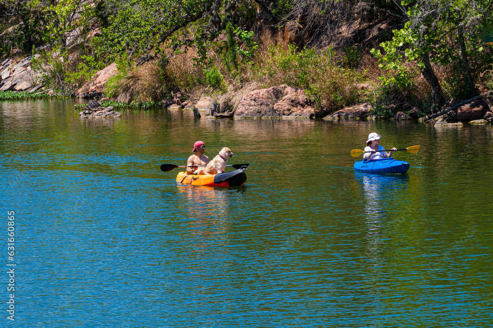 Kayakers With Yellow Lab Near Devils Waterhole at Inks Lake State Park, Burnet, Texas, USA Kayakers With Yellow Lab Near Devils Waterhole at Inks Lake State Park, Burnet, Texas, USA