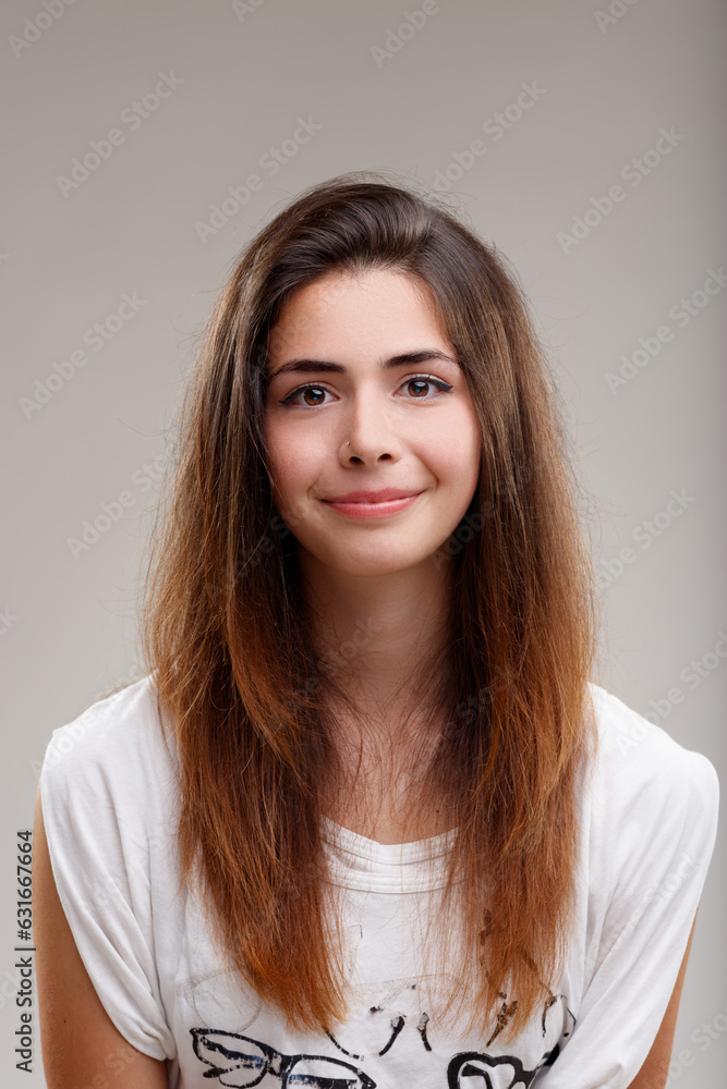 Long-haired girl smiles; adolescence symbolizes growth Long-haired girl smiles; adolescence symbolizes growth