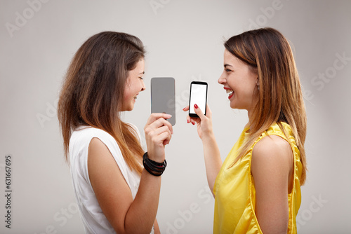 Two women exchange intriguing gossip, enjoy media