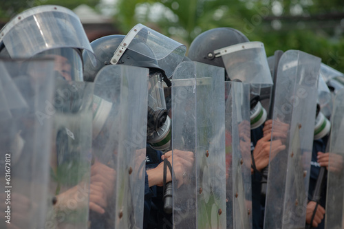 Riot police control the crowd.. photo