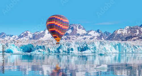 Hot air balloon flying over Knud Rasmussen Glacier near Kulusuk - Greenland, East Greenland photo
