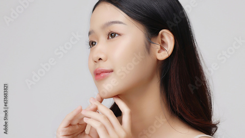 Young beauty Asian girl with Korean makeup style touch her face gently on isolated background. Facial treatment, Cosmetology.