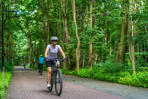 Fototapeta Naklejka Na Ścianę i Meble -  Woman riding bicycle in forest
