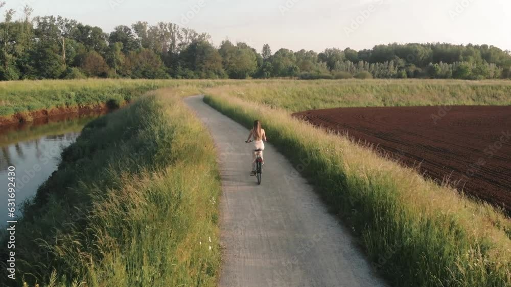 Drone video of a cycling girl in Flanders Belgium Drone video of a cycling girl in Flanders Belgium